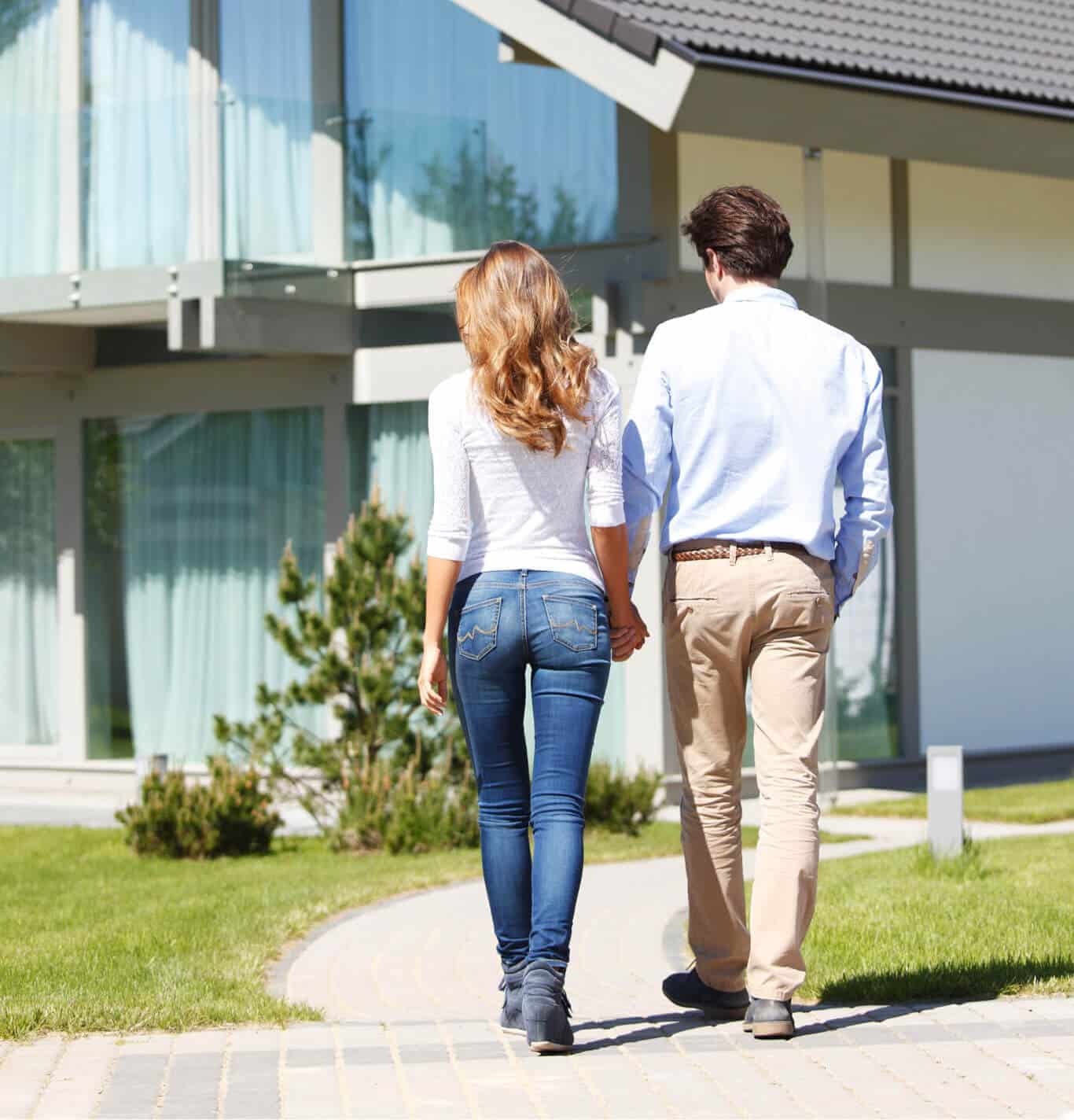 Homeowners walking toward their well-maintained roof