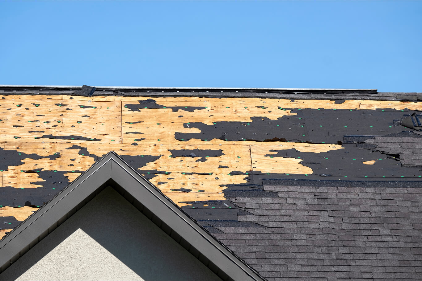Storm-damaged roof with missing shingles