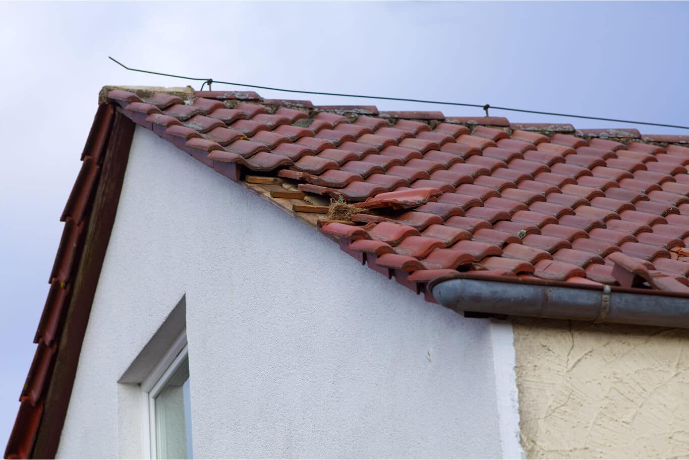 Roof with fallen shingles needing emergency repair