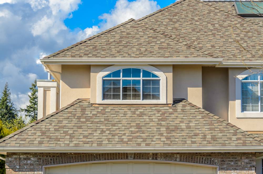 Residential asphalt roof in Chino Valley showing recent repairs