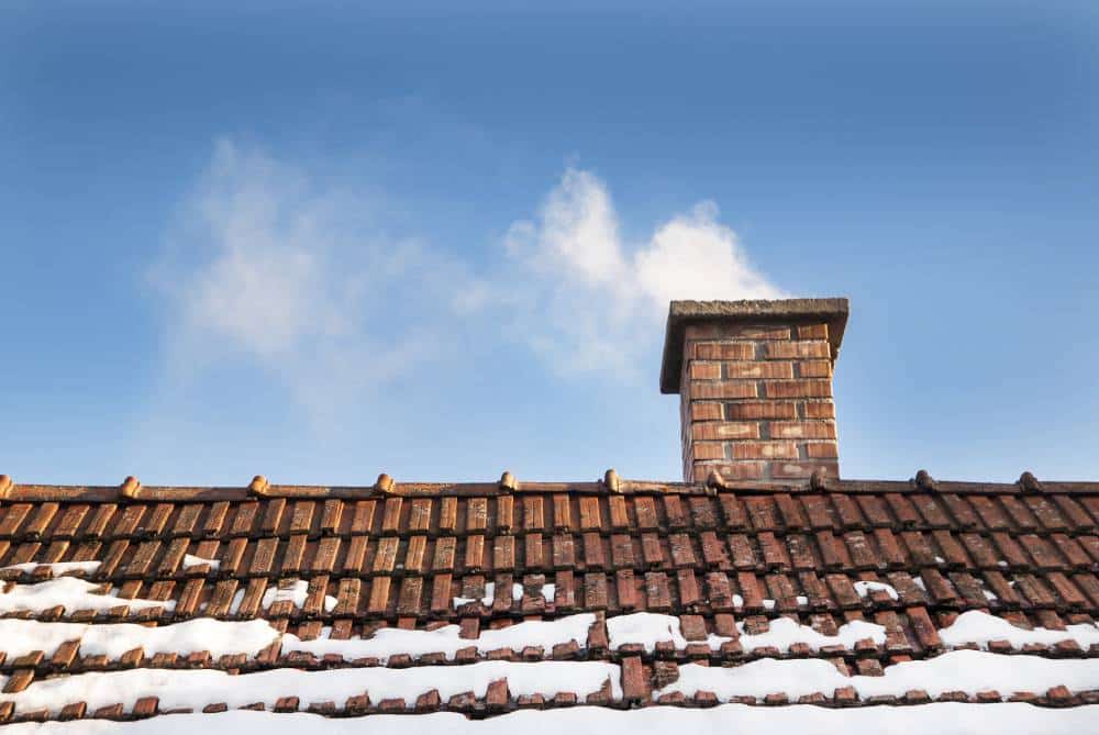 Home with snow-damaged roof needing urgent repair