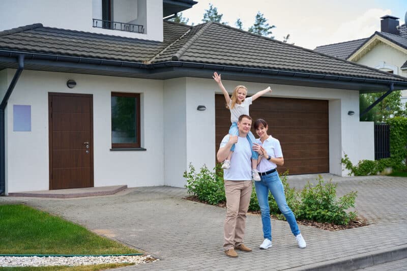 Family outside home after emergency roof repair in Prescott