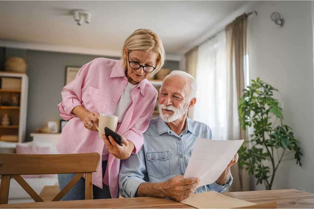 Senior couple reviewing roof estimate