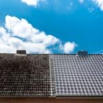 A split roof showing before-and-after cleaning, with dark stained tiles on the left and clean gray tiles on the right.