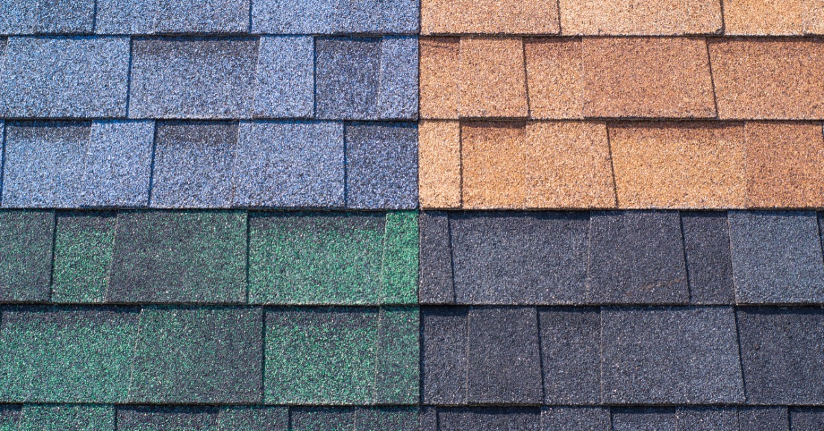 A close-up of four asphalt shingle panel samples in blue, brown, green, and charcoal, all arranged in a grid.